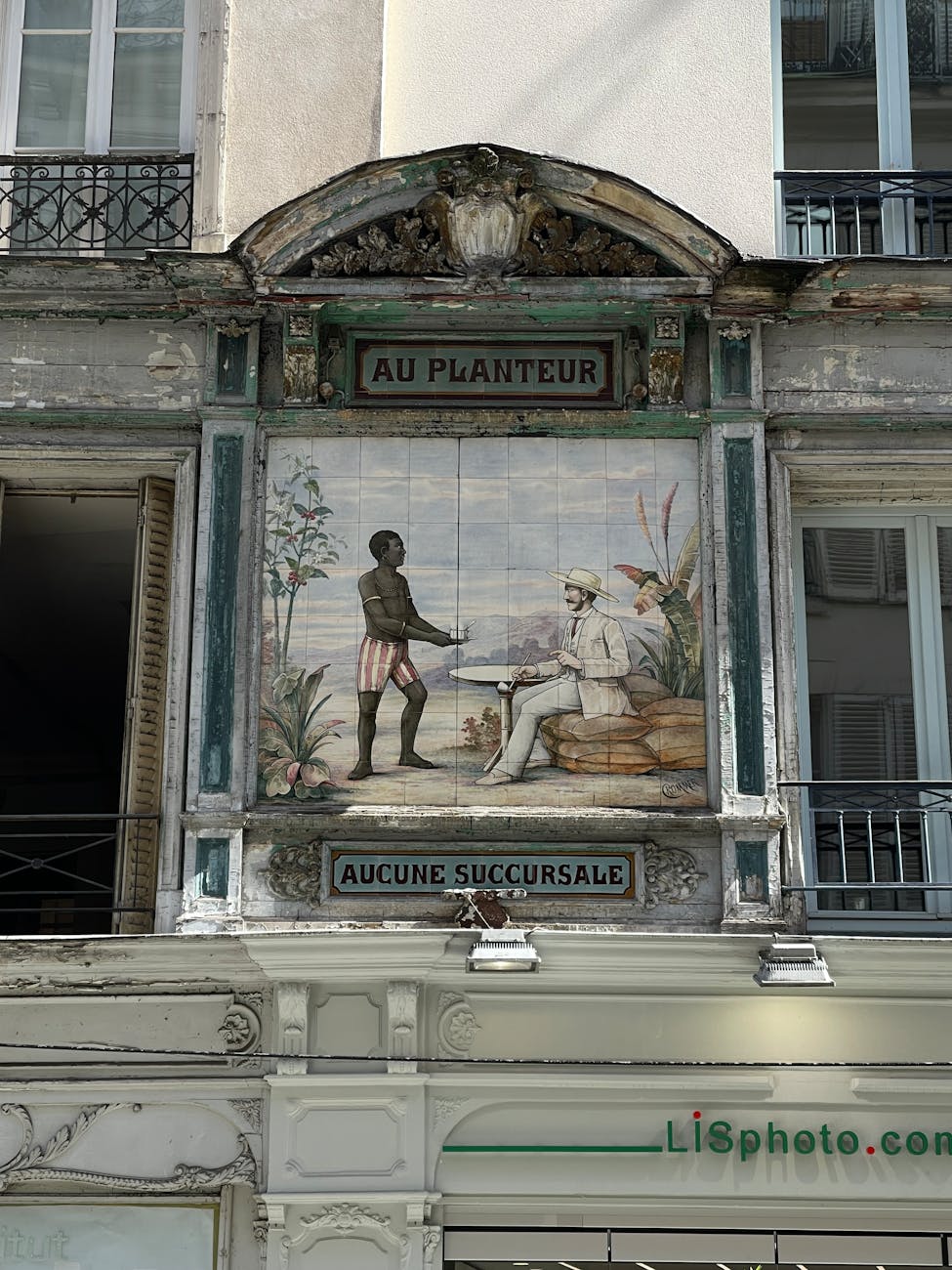A detailed colonial-era mural on a historic building facade, capturing urban art.