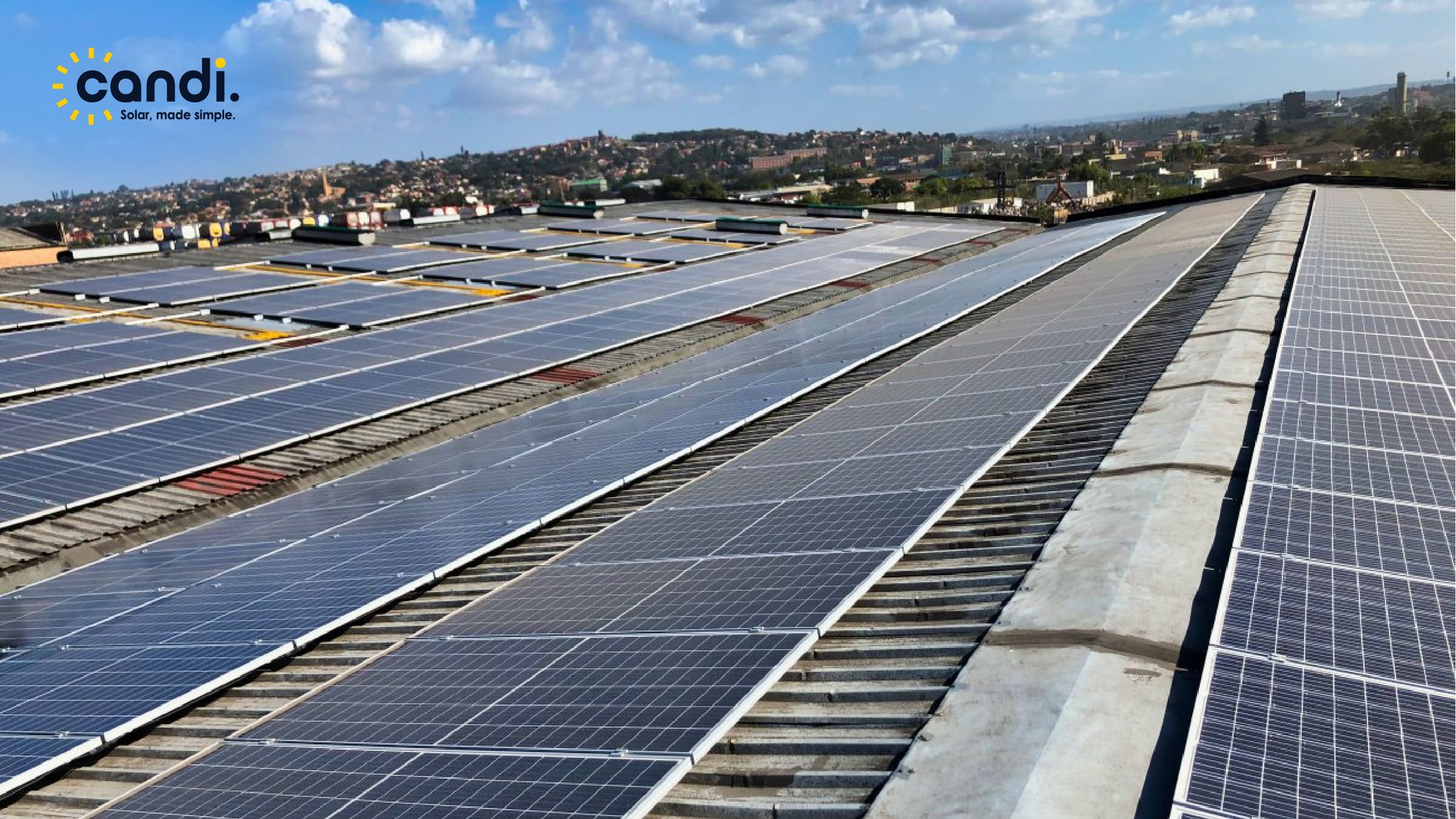 Aerial view of a commercial warehouse rooftop covered in Candi Solar panels