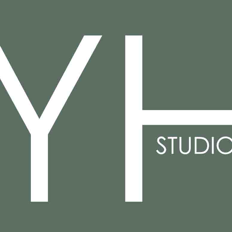 White capital letters Y and H with the word STUDIO on a muted green background.