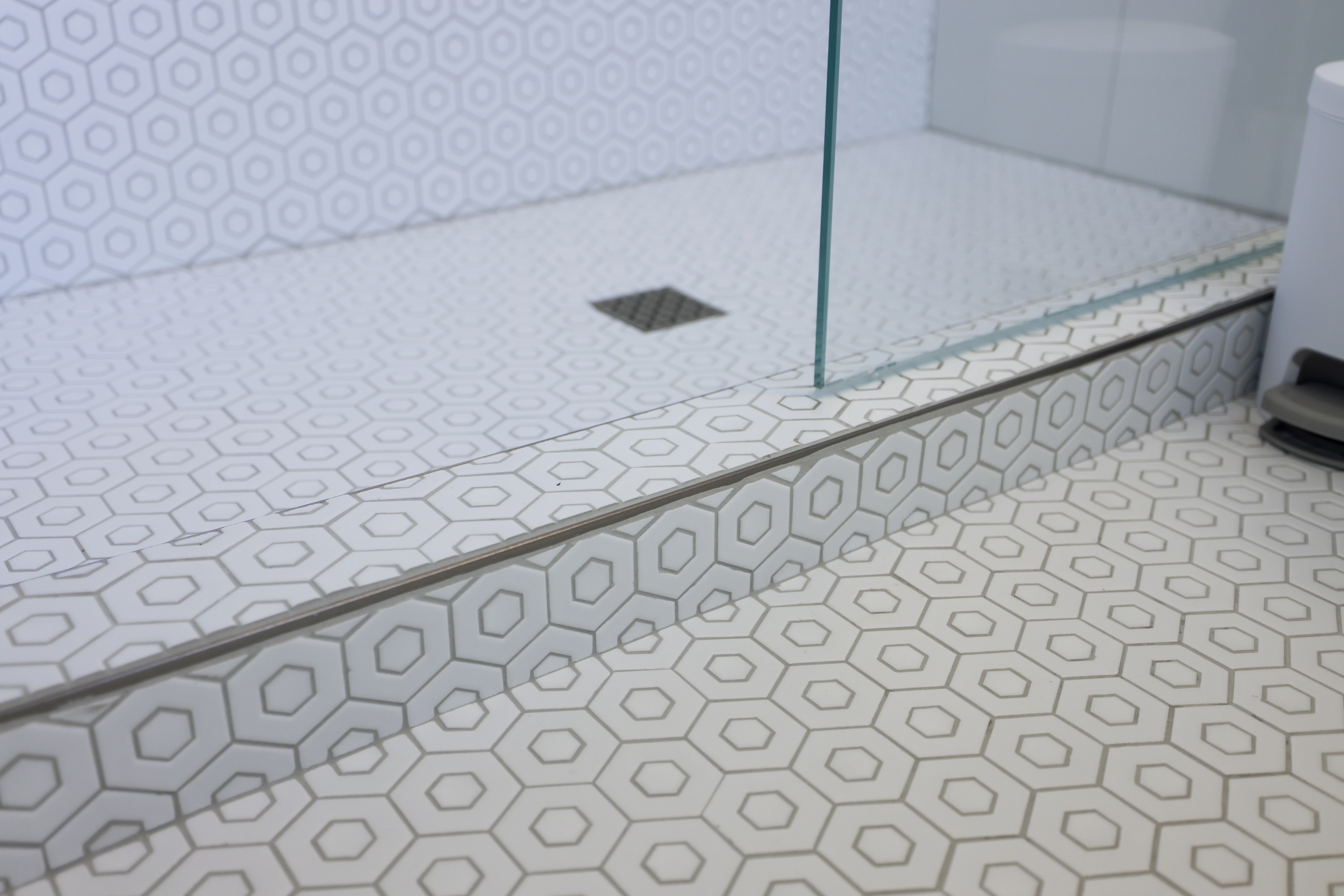 photo - a close up of a tiled walk in shower floor 