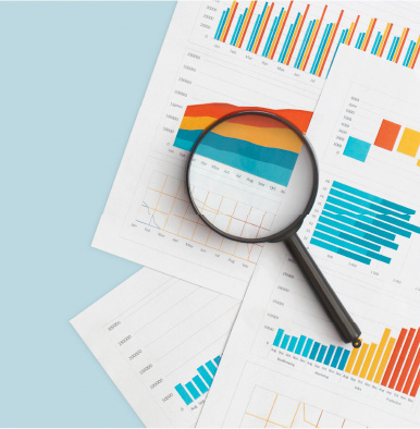 Pages of charts with a magnifying glass