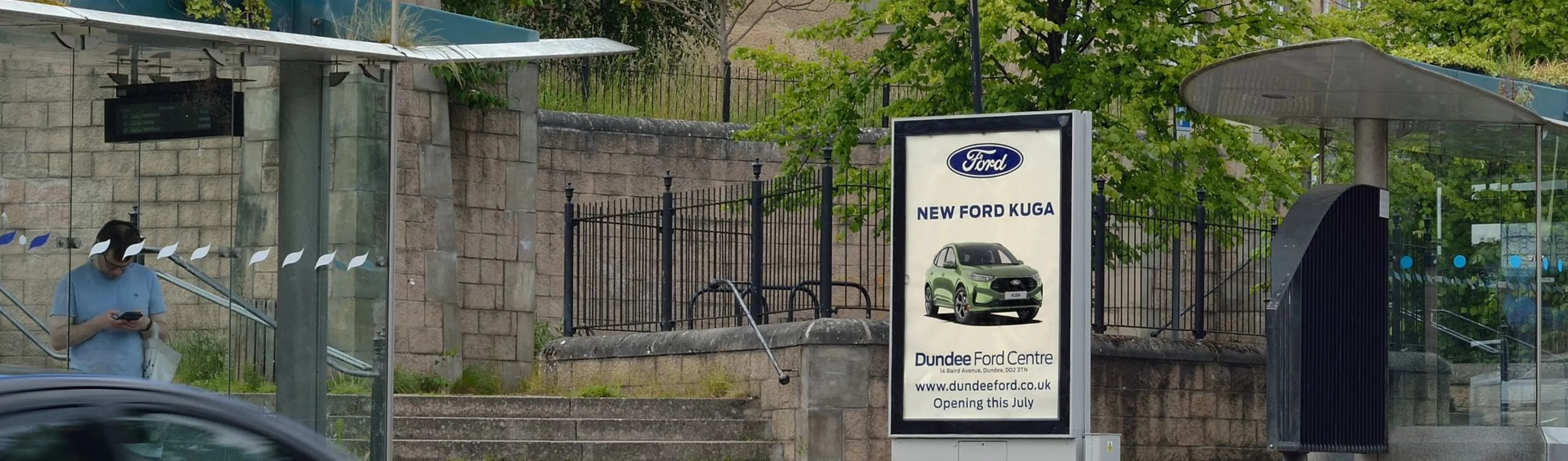 An outdoor poster campaign featuring a Ford car advert