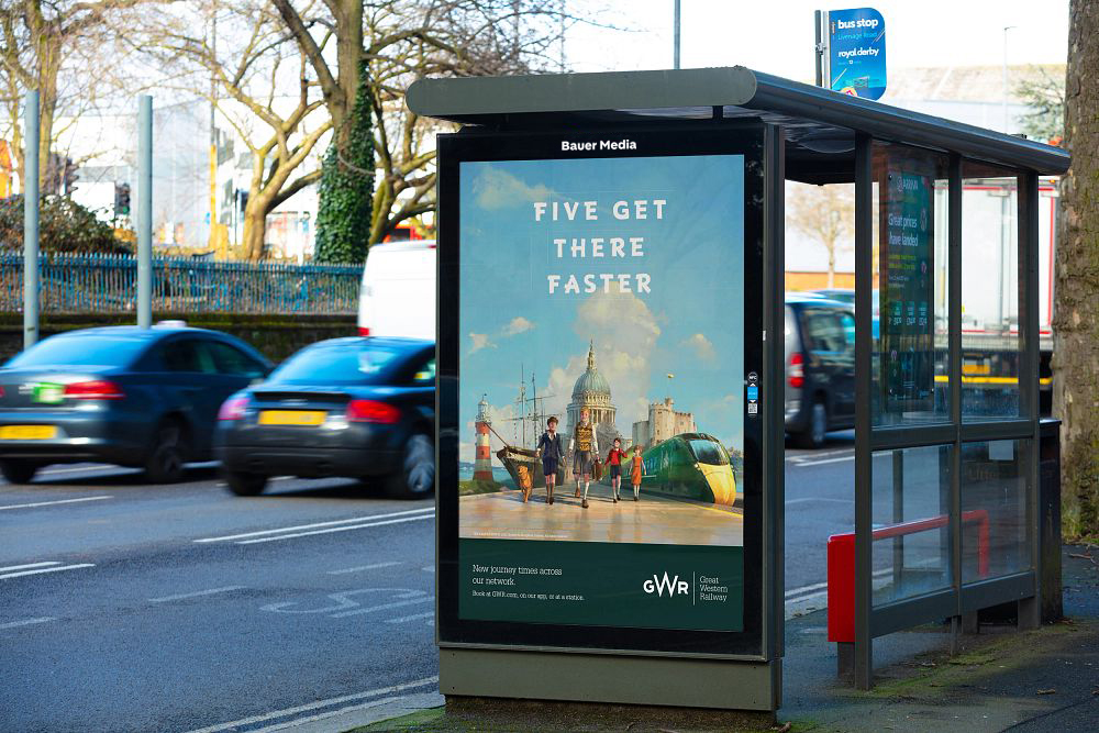 A Bauer Media Outdoor bus stop poster displaying a rail advert