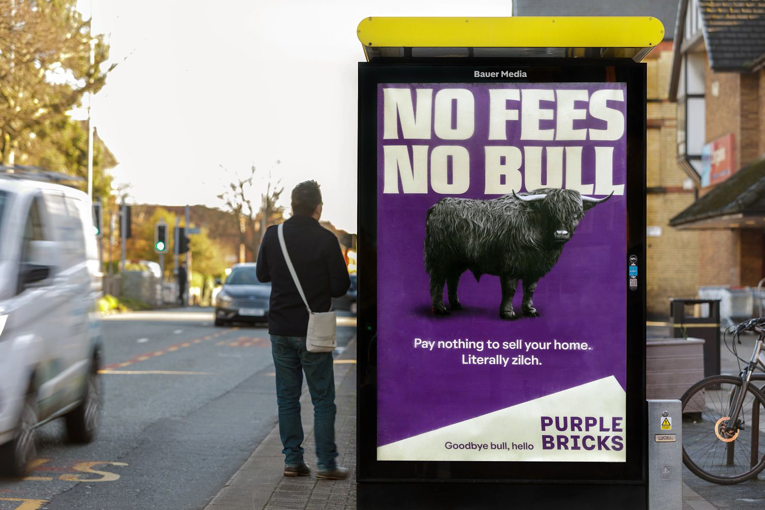 Purple Bricks advertising on a Bauer Media Outdoor bus shelter poster, featuring a bull