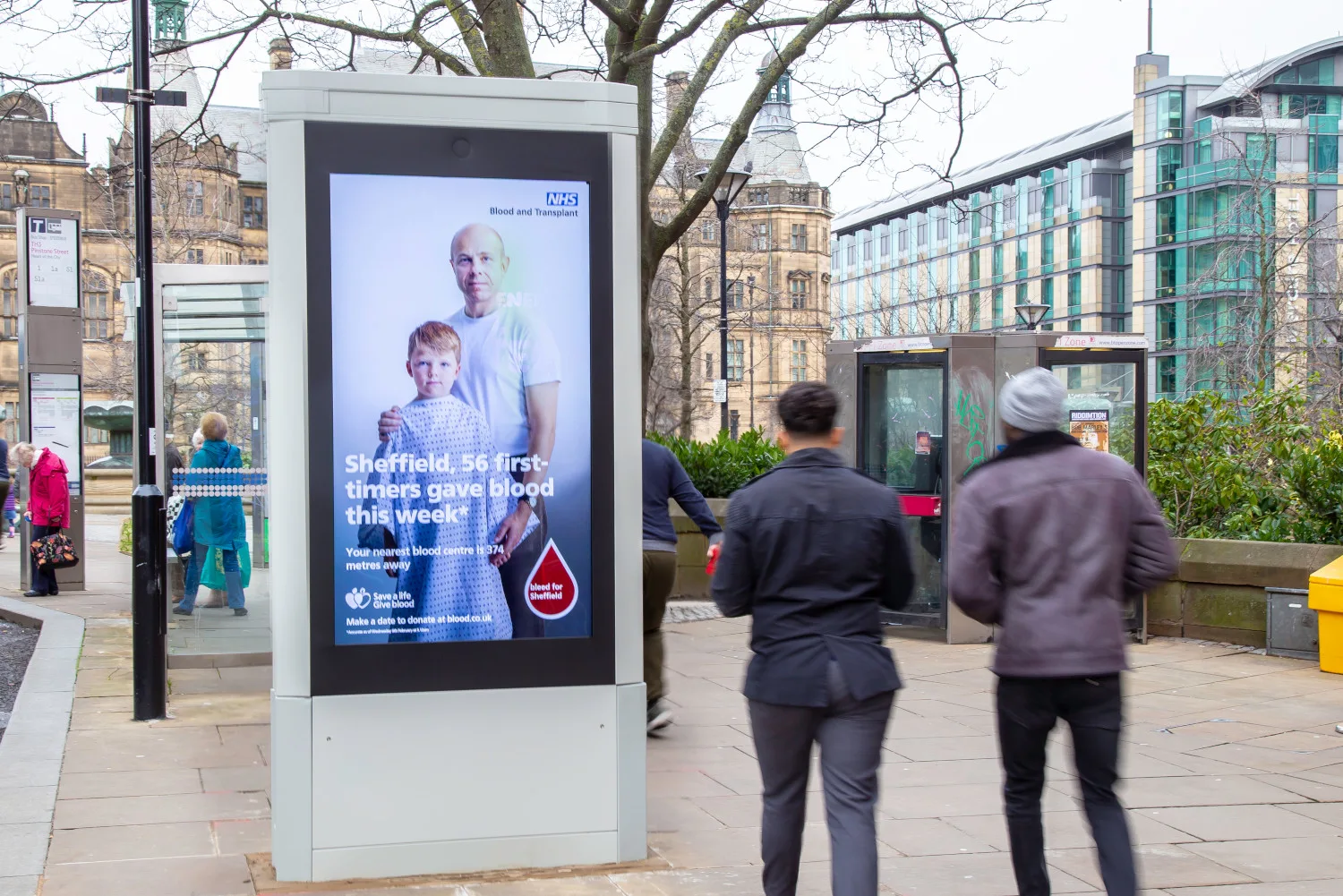 A NHS advertising campaign on a high street digital screen