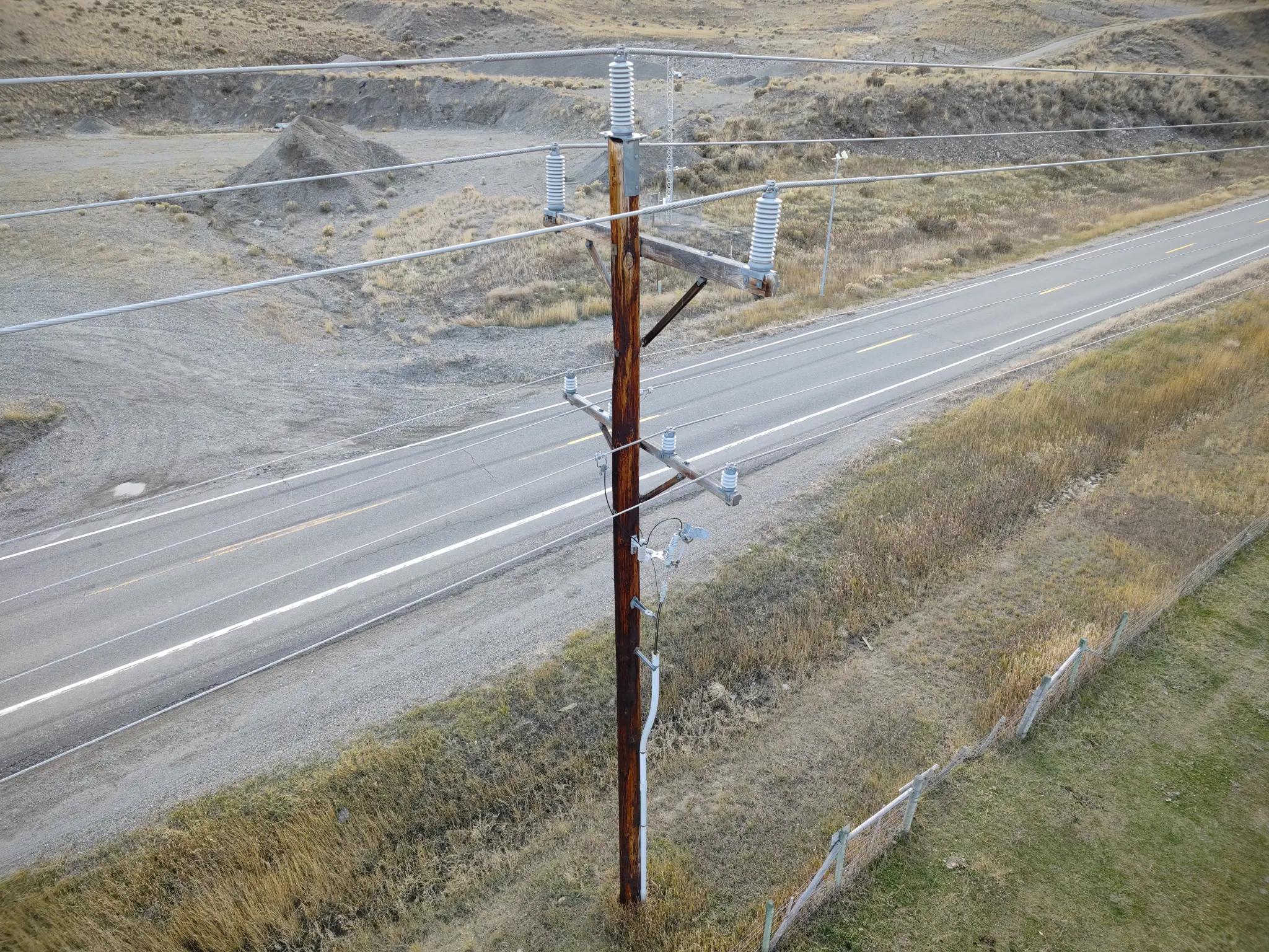 Picture of power line by the side of the road captured by drone.