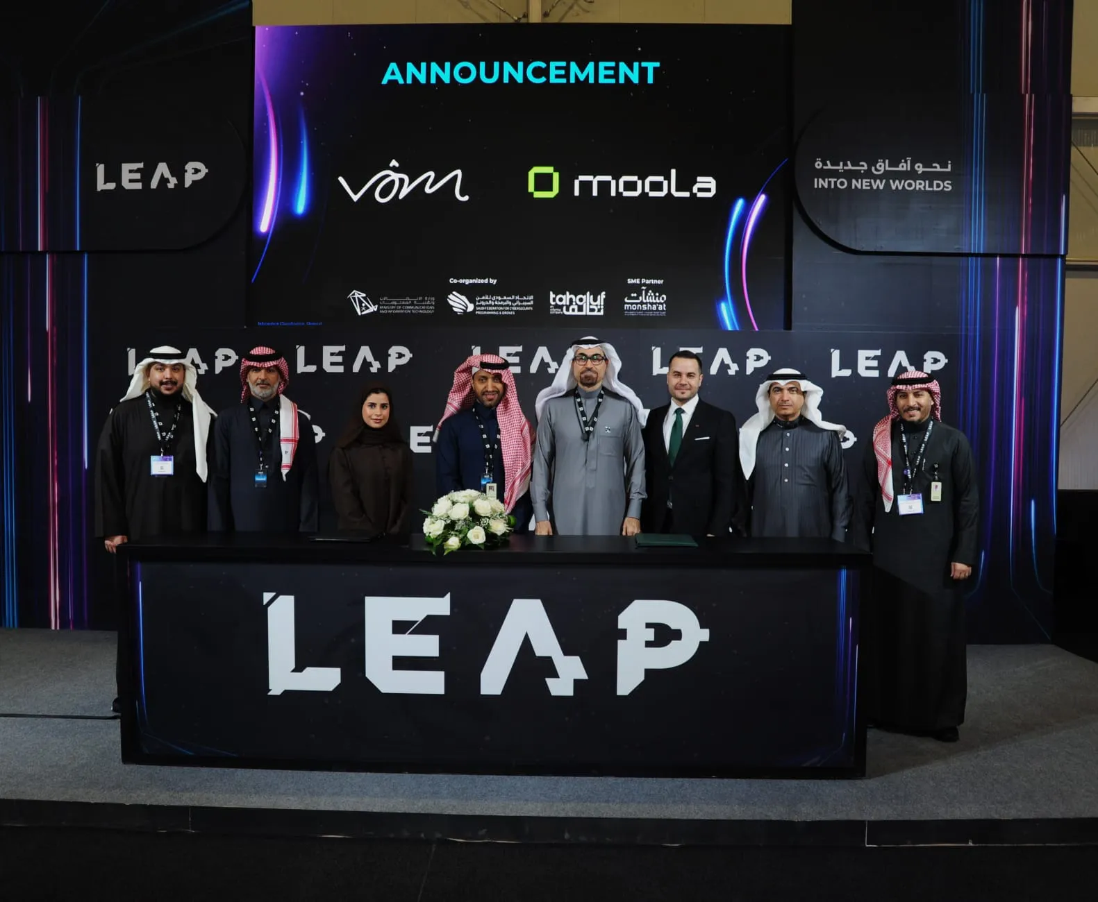 Hands holding a tablet displaying financial data with text highlighting how Bayt Al Jaleed cut manual expense work by 80% and boosted financial transparency by 90% using Moola in 12 weeks.