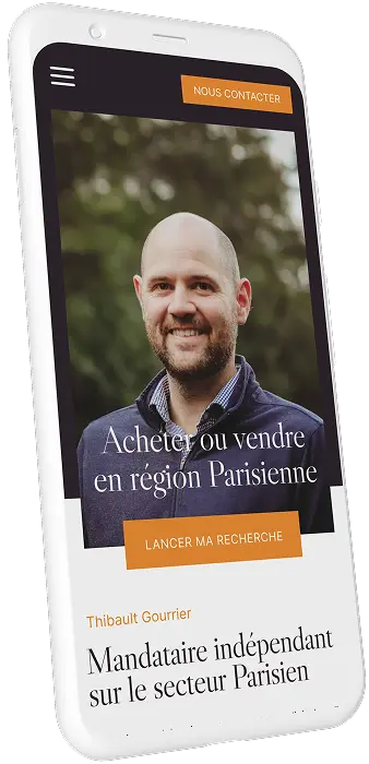 Smartphone displaying a real estate app screen with a smiling bald man, text about buying or selling in the Paris region, and a call-to-action button 'LANCER MA RECHERCHE'.