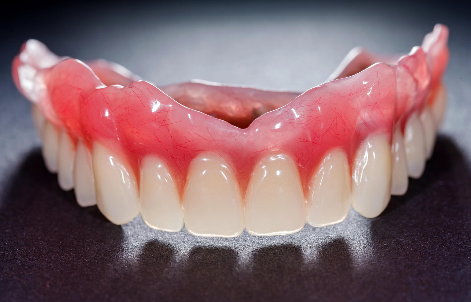 Coral Gables Dentures over black surface