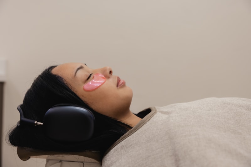 Patient relaxed in dental chair with head reclined, receiving oral care