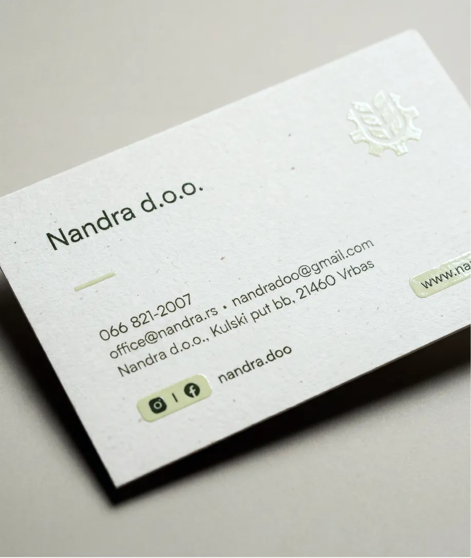 Business card for Nandra d.o.o. showing contact phone number, two email addresses, physical address in Vrbas, and social media icons for Instagram and Facebook.