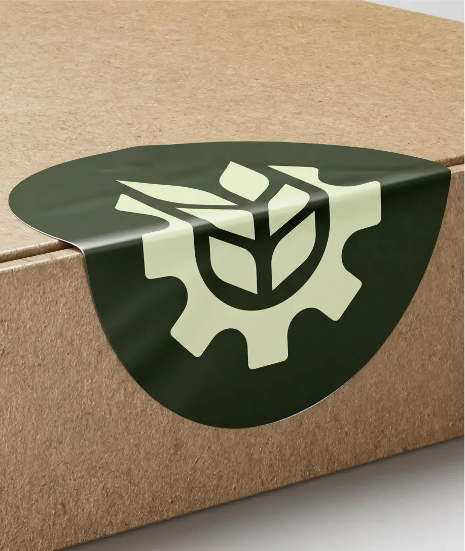 Dark green circular sticker sealing a cardboard box, featuring a light green gear with a leaf inside.