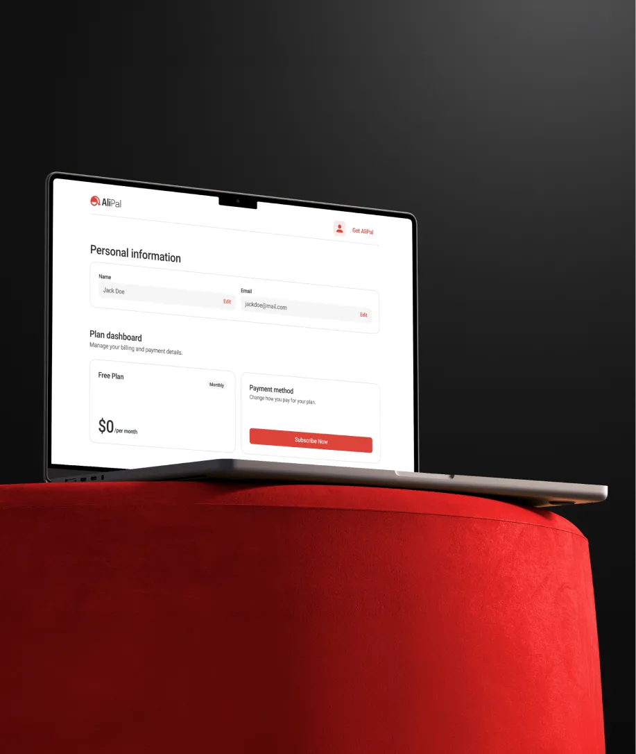 Open laptop displaying AliPal user dashboard with personal information and subscription plan details on a red surface against a black background.