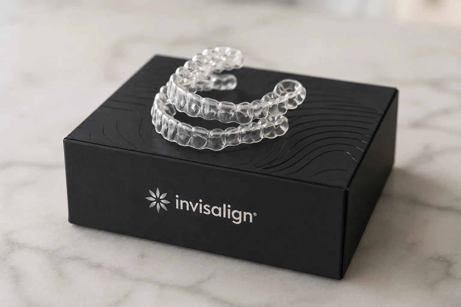 Clear Invisalign aligners displayed in an open black case