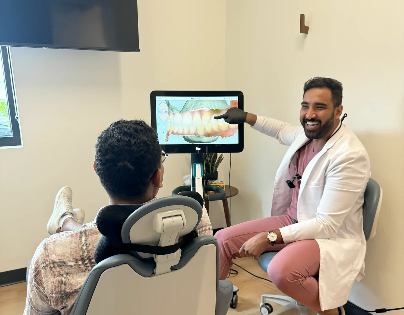 Dr. Sajan Parag reviewing a digital cosmetic treatment plan with a patient.