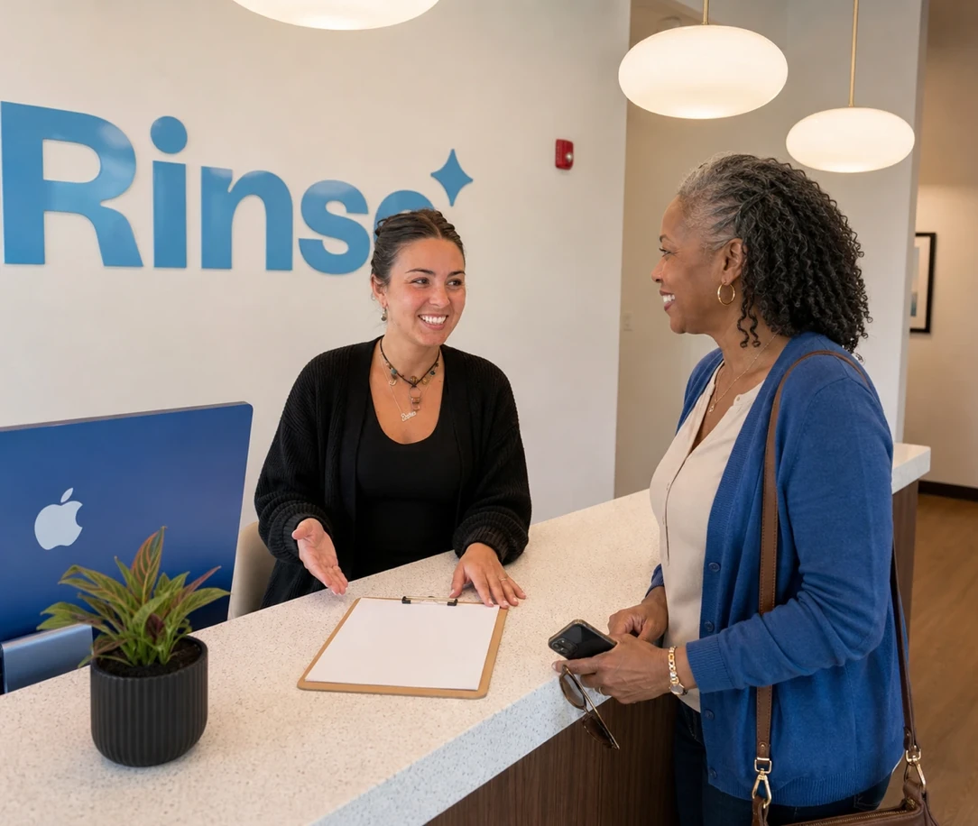 Rinse Dental team member welcoming a patient at reception