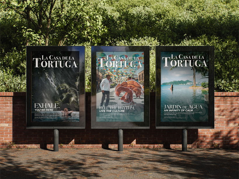 Three outdoor framed posters on brick wall promoting La Casa de la Tortuga with images of a person at water, dancers under colorful umbrellas, and a serene pool with a person standing.