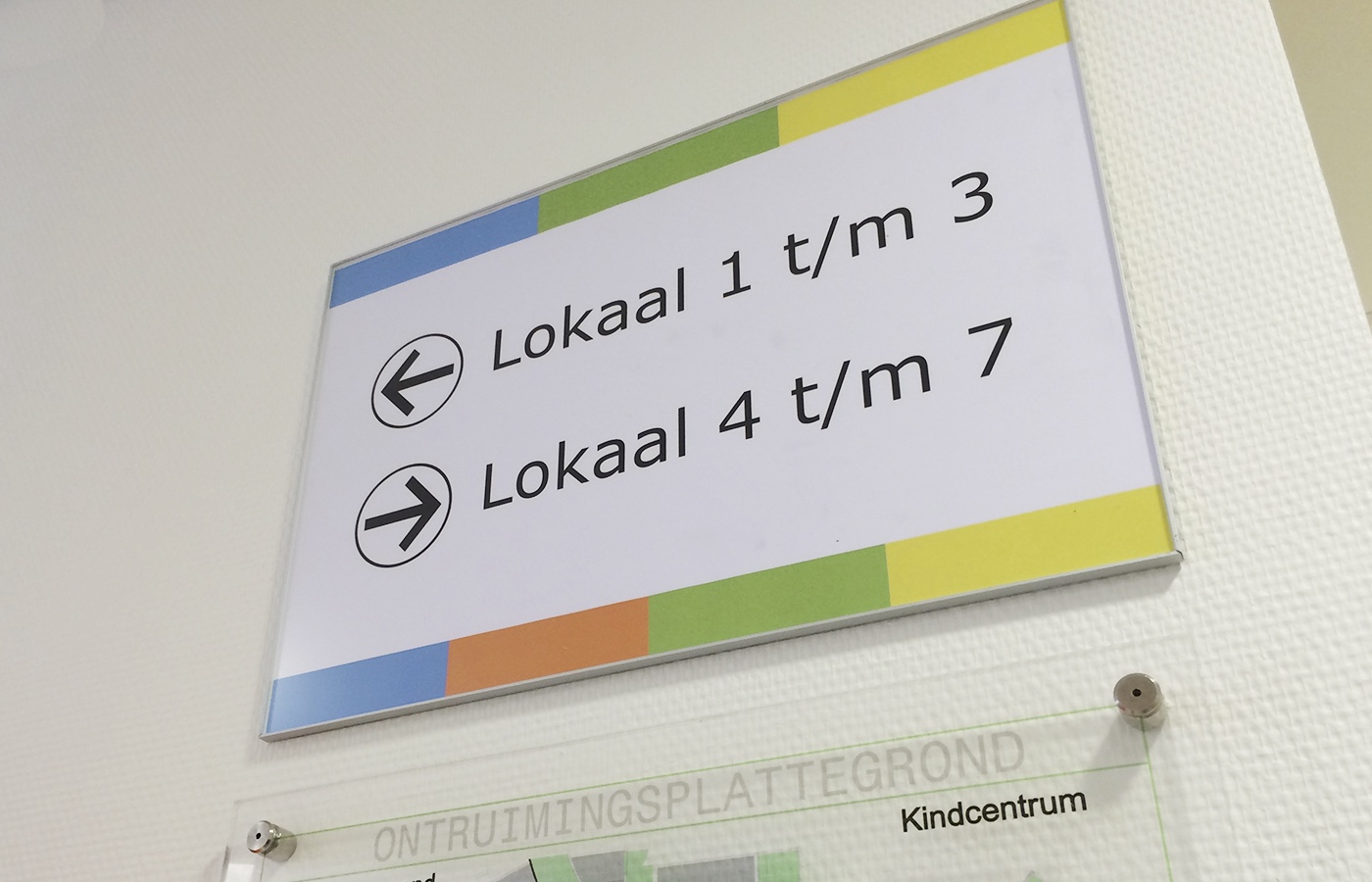 Bord met aanwijzing dat kamers 1 tot 3 naar links en kamers 4 tot 7 naar rechts liggen.