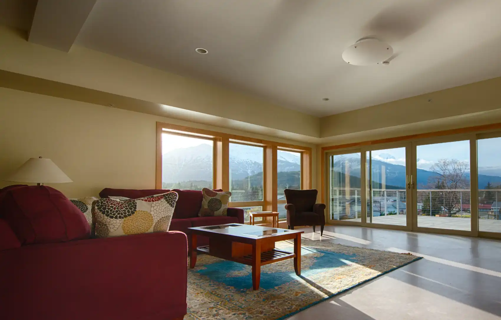 Community room with large corner windows with a view and sliding doors to a deck.