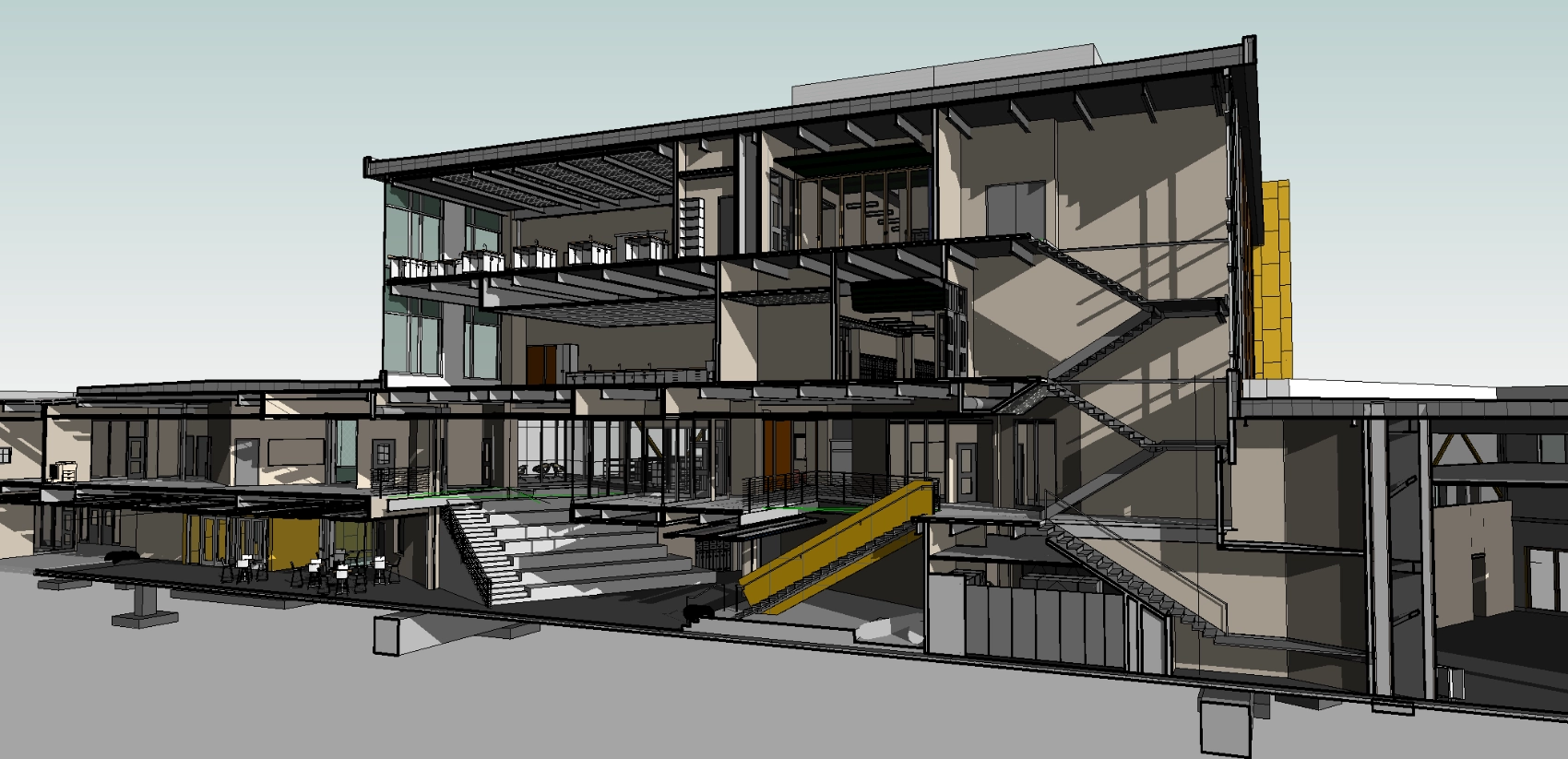 Cross section of a computer model of a school showing stairs and openings between levels.
