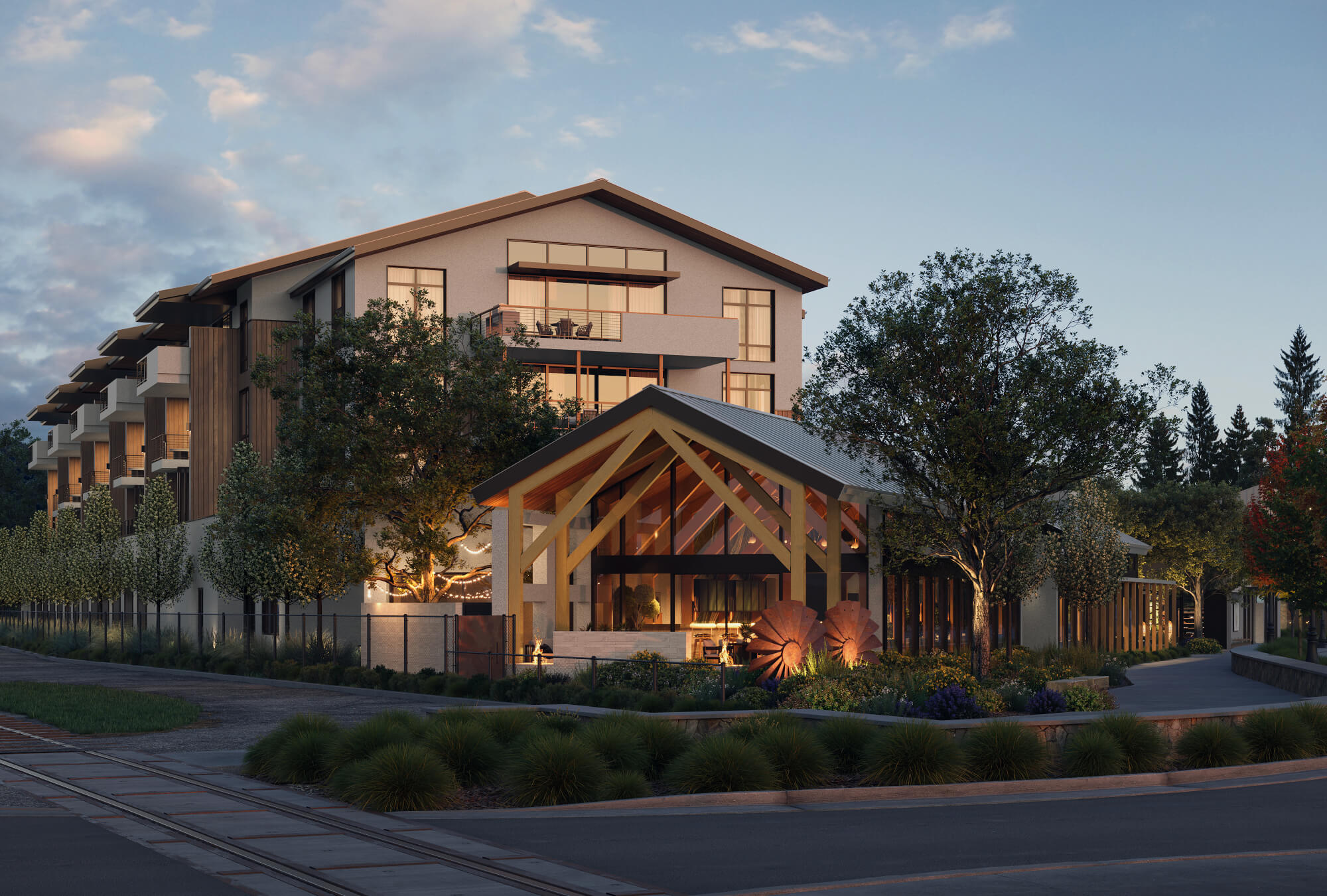 Modern multi-story building with wooden accents and glass entrance, surrounded by trees and warm evening lighting.