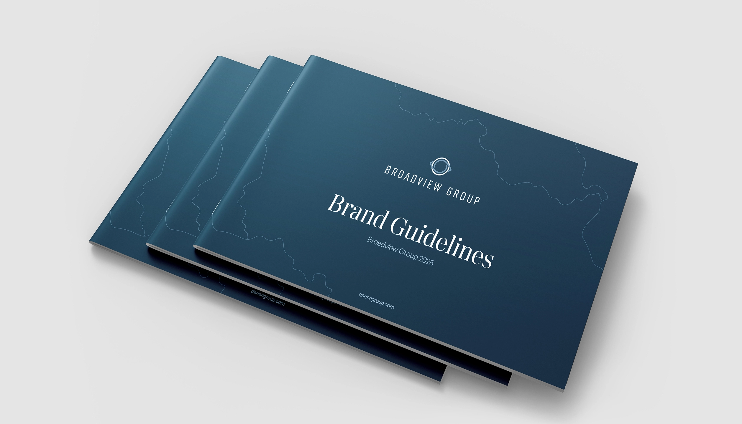 Stack of three blue booklets titled 'Brand Guidelines' by Broadview Group, with a subtle abstract line design on the covers.