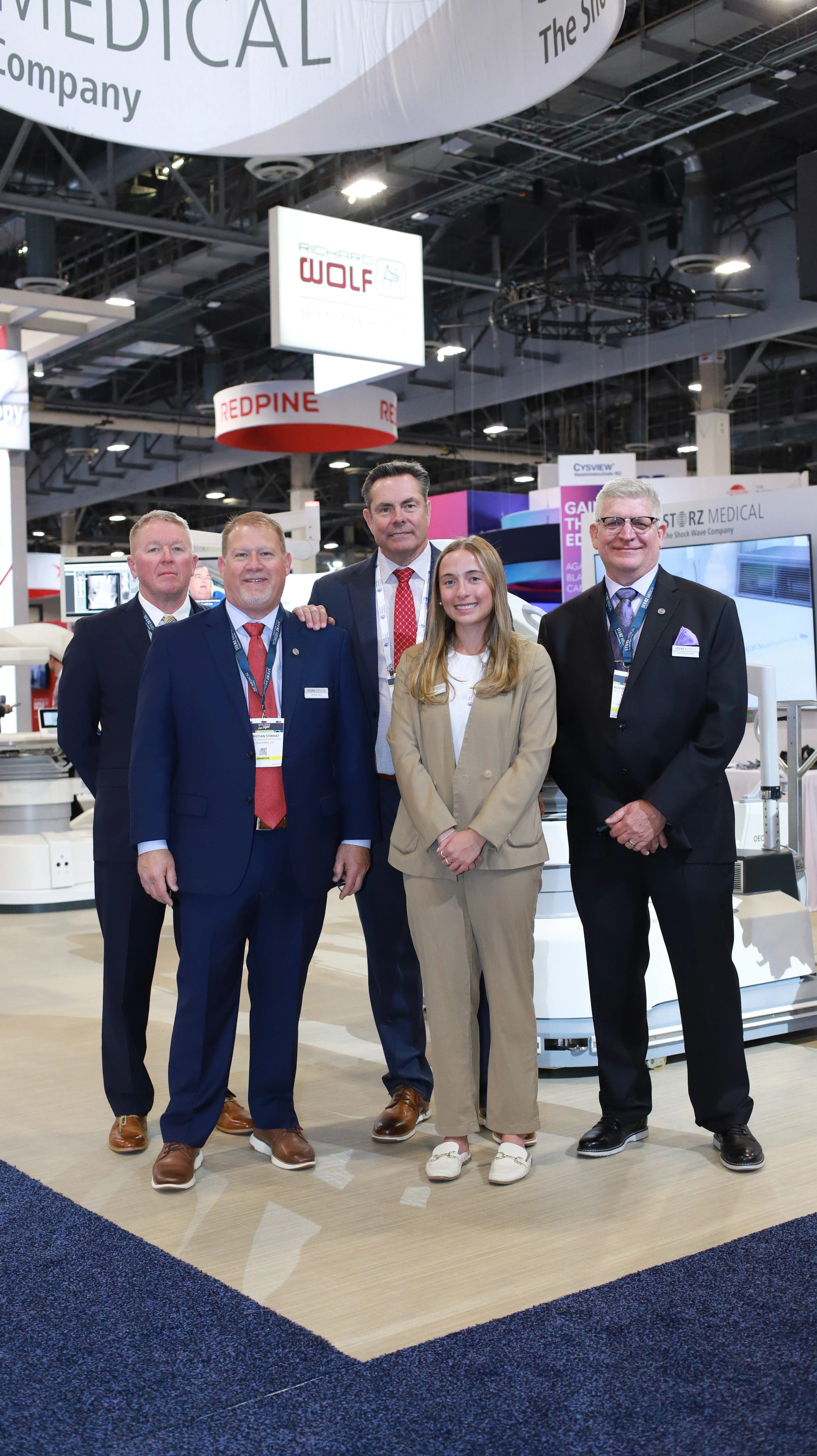 STORZ Medical team members posing together at a trade show conference booth