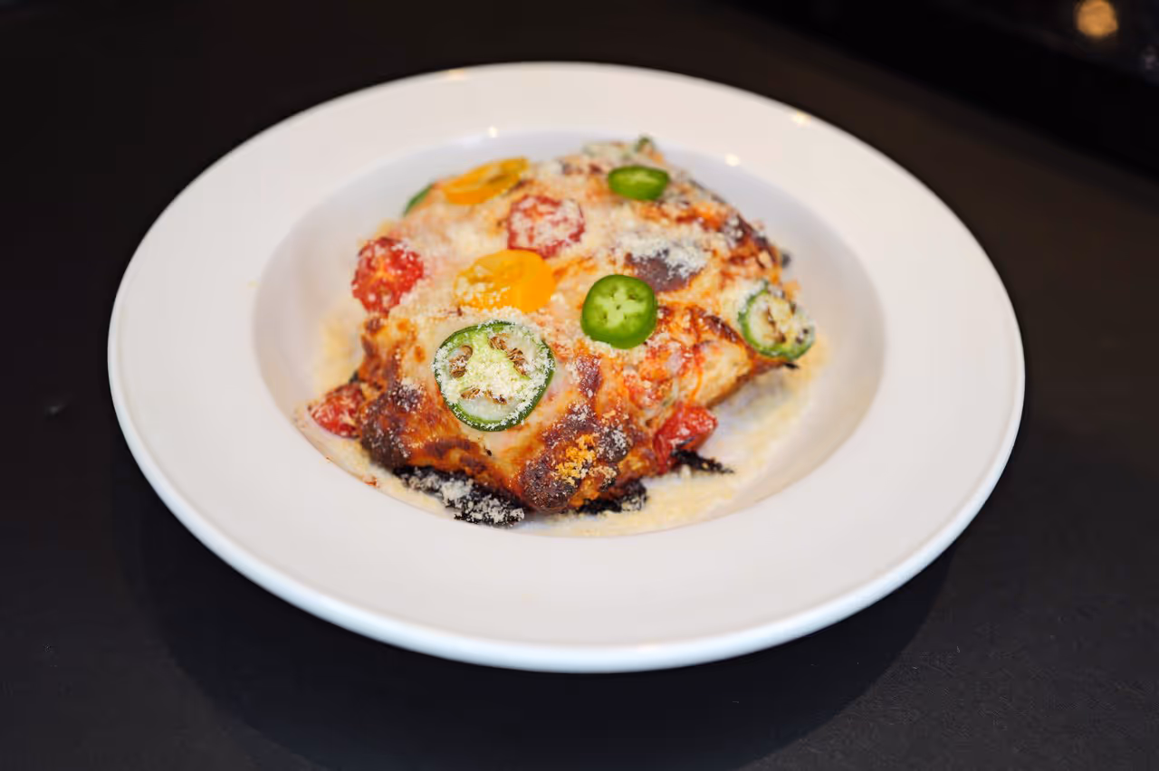 A white plate with a slice of pizza on it.