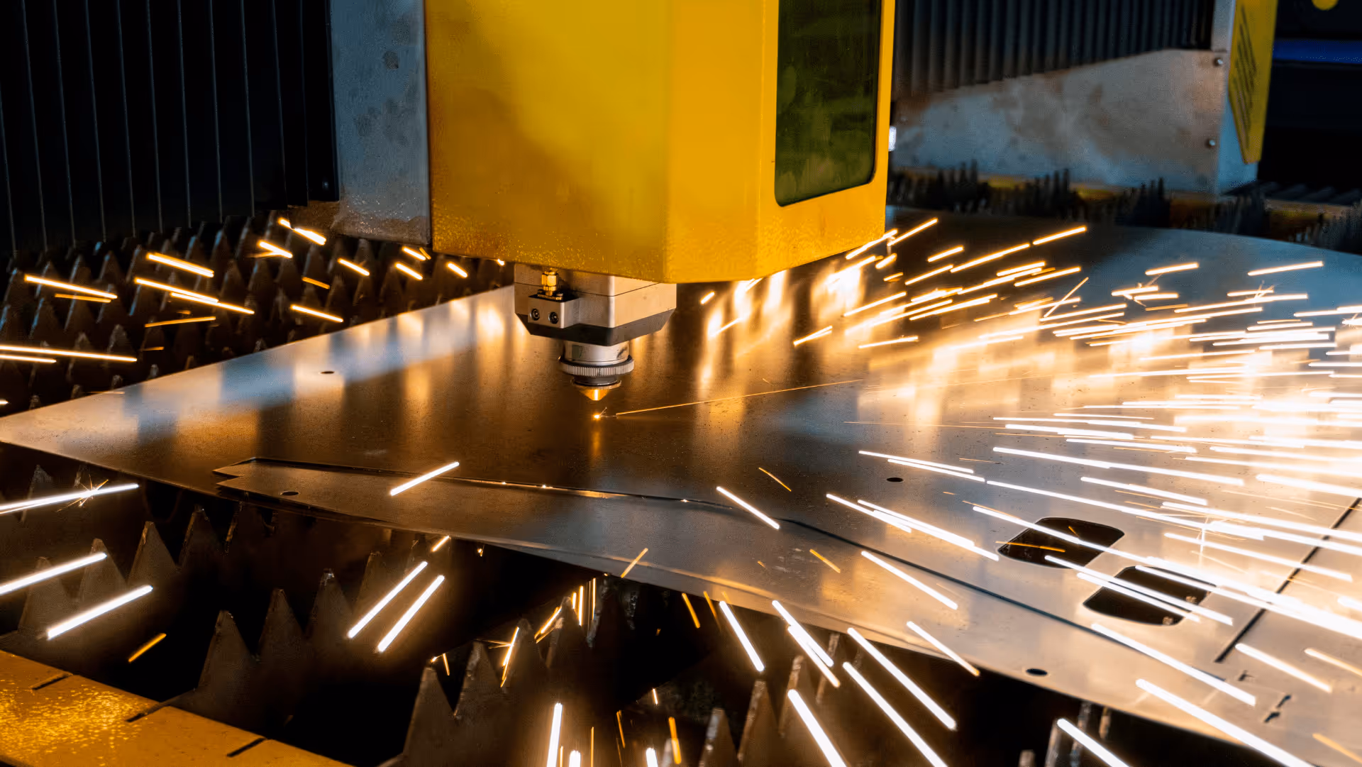 Yellow plasma cutter head cutting metal