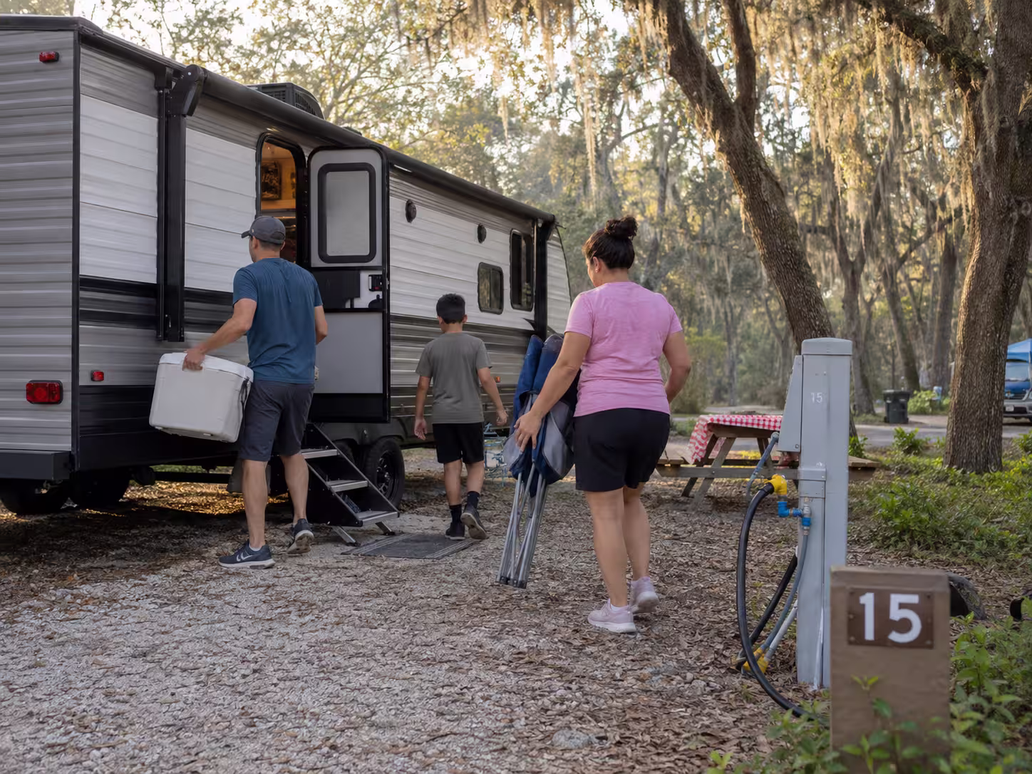 Family loading a bunkhouse travel trailer rental in Orlando, Florida