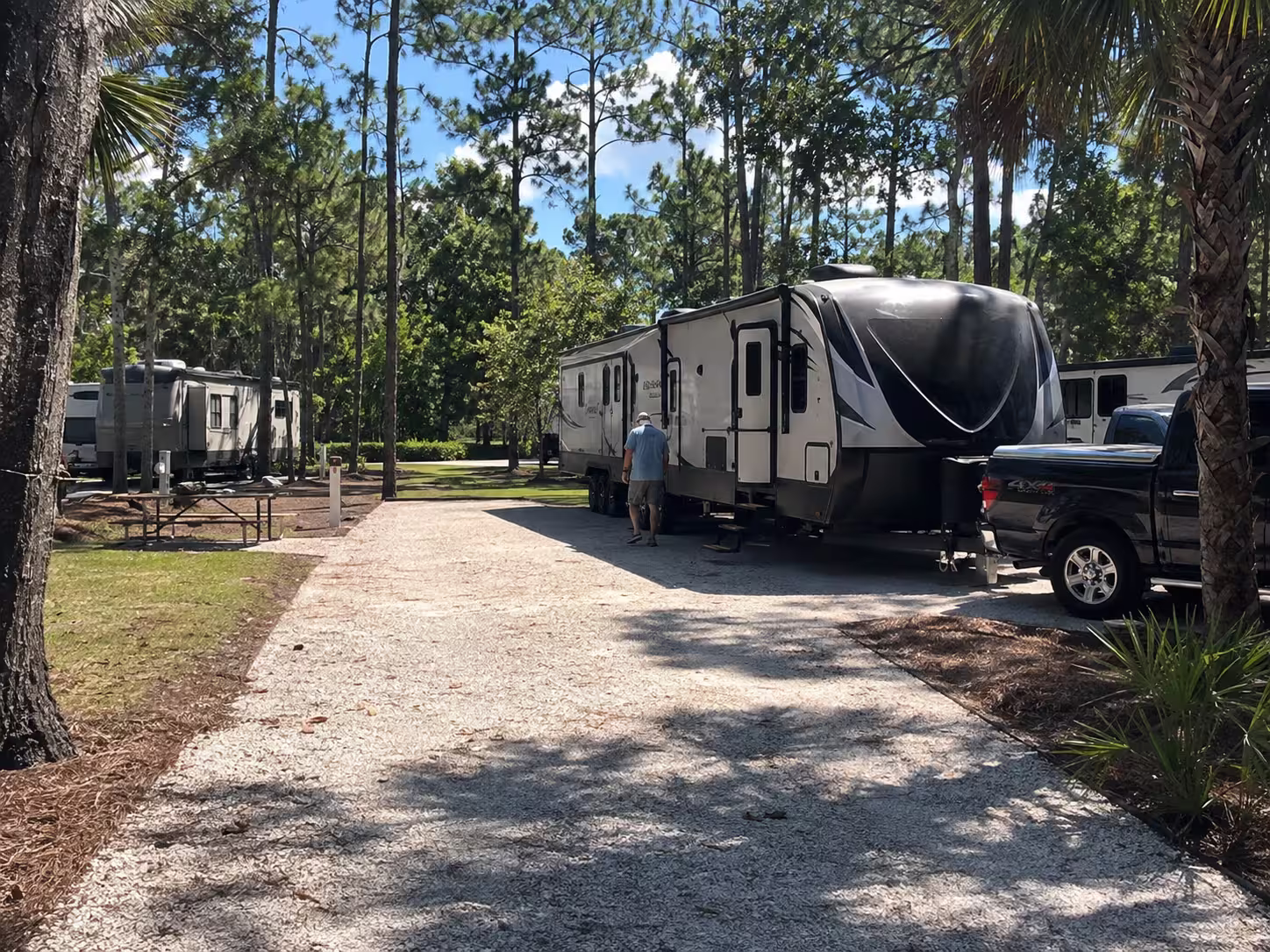 Large RV rental being placed on a wide campsite near Orlando