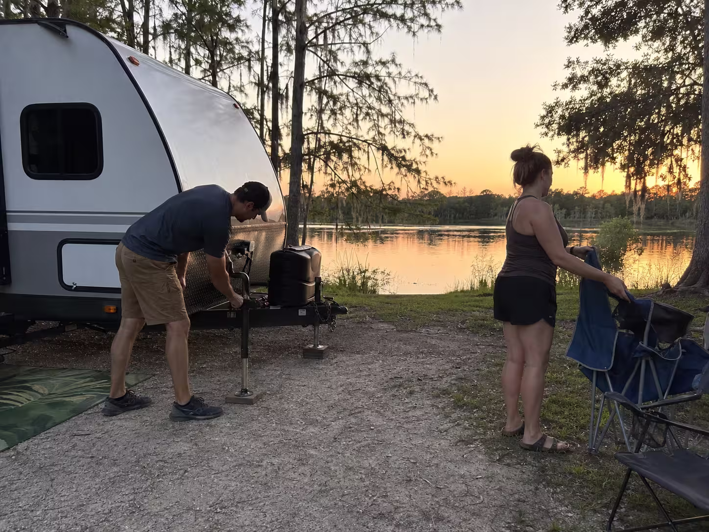 Couple setting up a small RV rental near a Central Florida lake