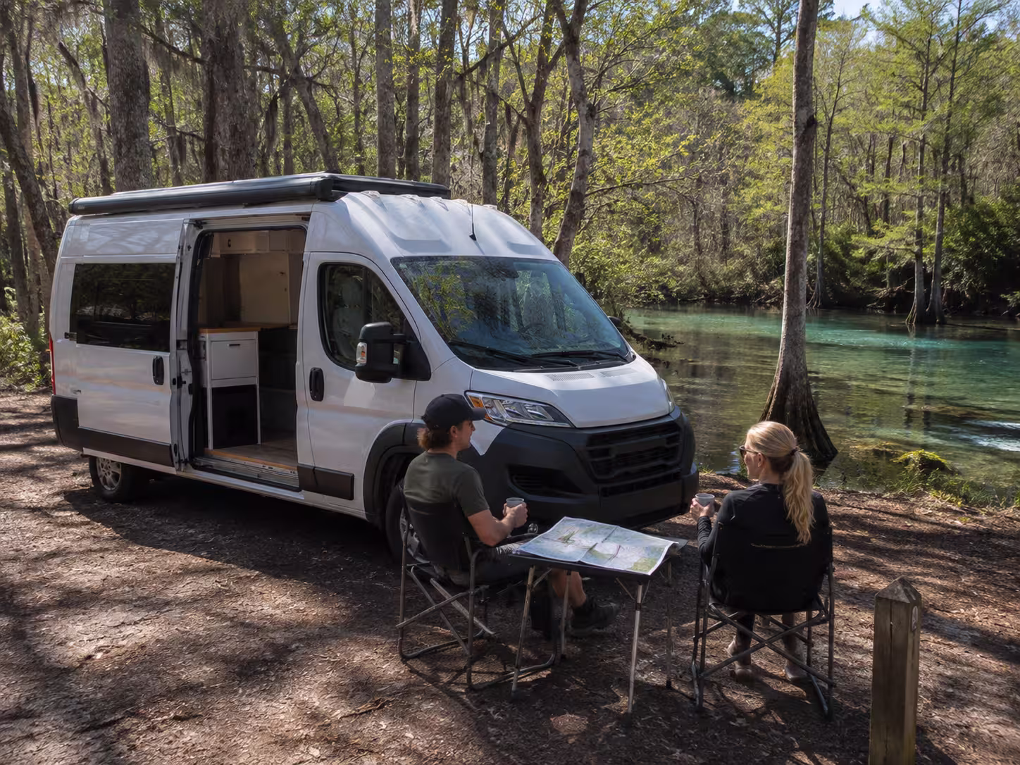 Couple camping with a Class B van rental near an Orlando spring