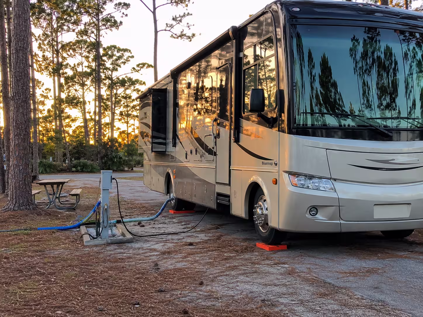 Class A motorhome connected at a full hookup site near Orlando