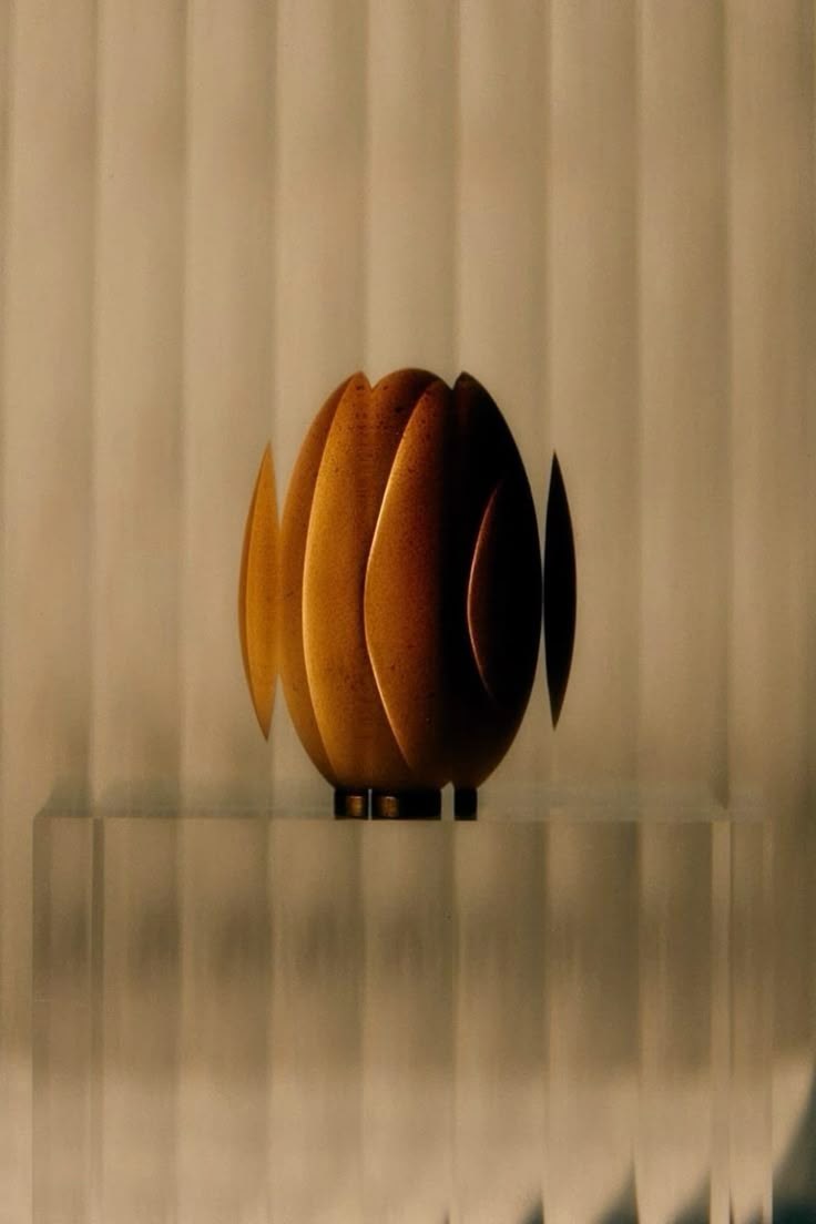 Fluted amber jar against a ribbed cream backdrop