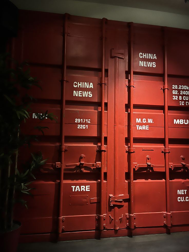 Red freight containers stacked in a warehouse yard