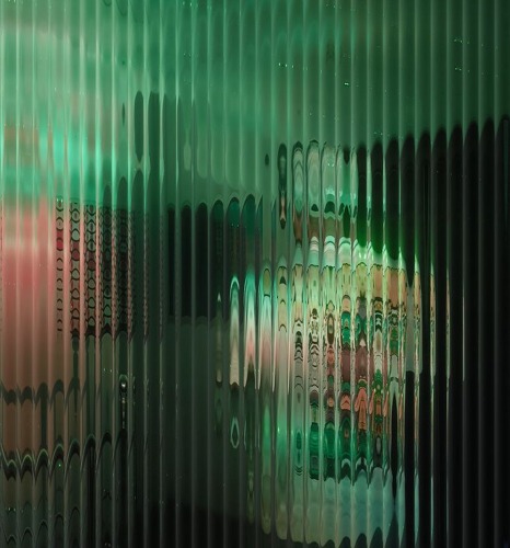 Green fluted glass panel diffusing packaging behind it