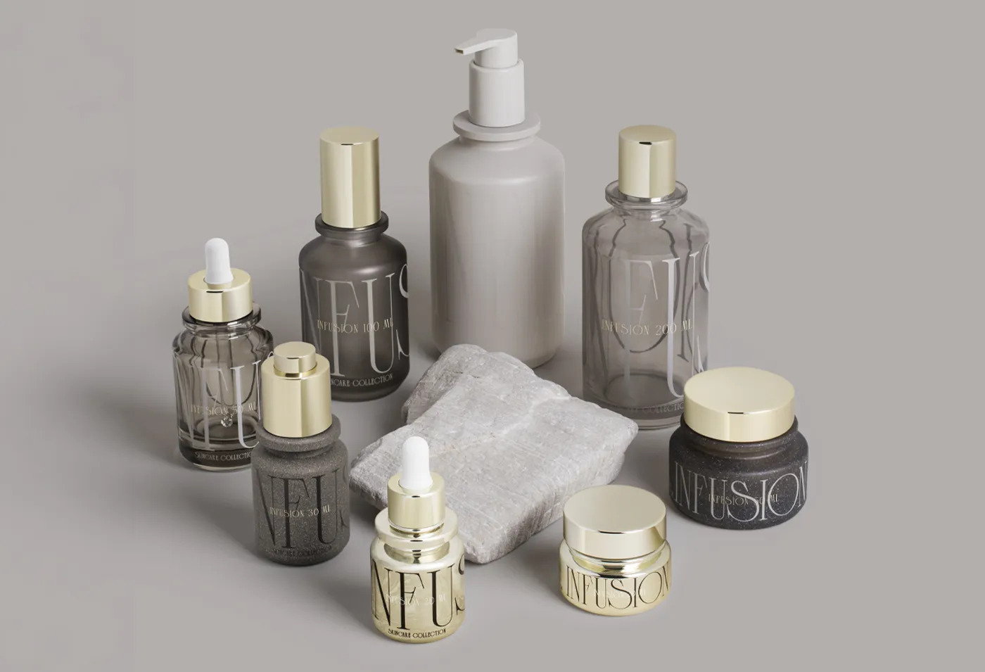 A set of grey and amber cosmetic bottles and jars with gold caps