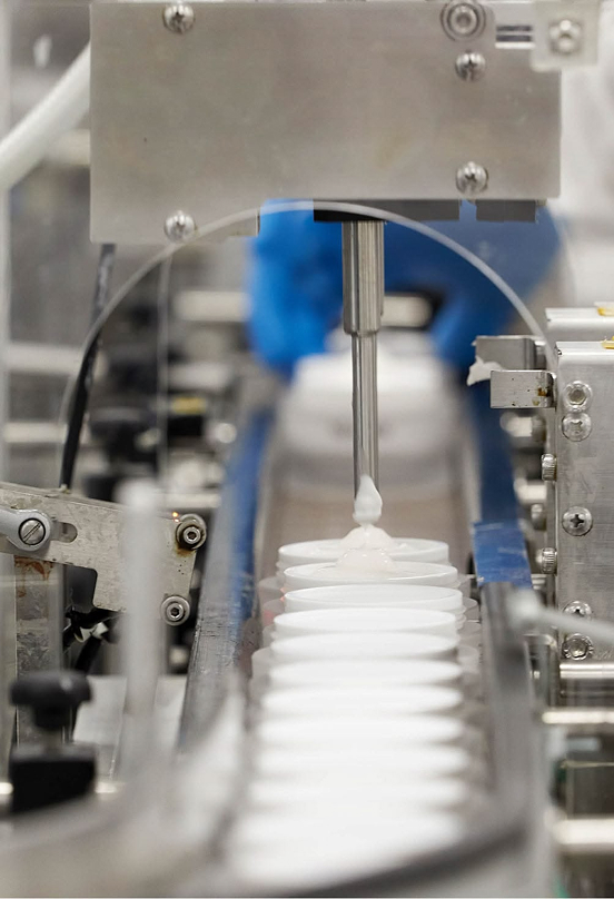 Stainless filling nozzle dispensing product into a container
