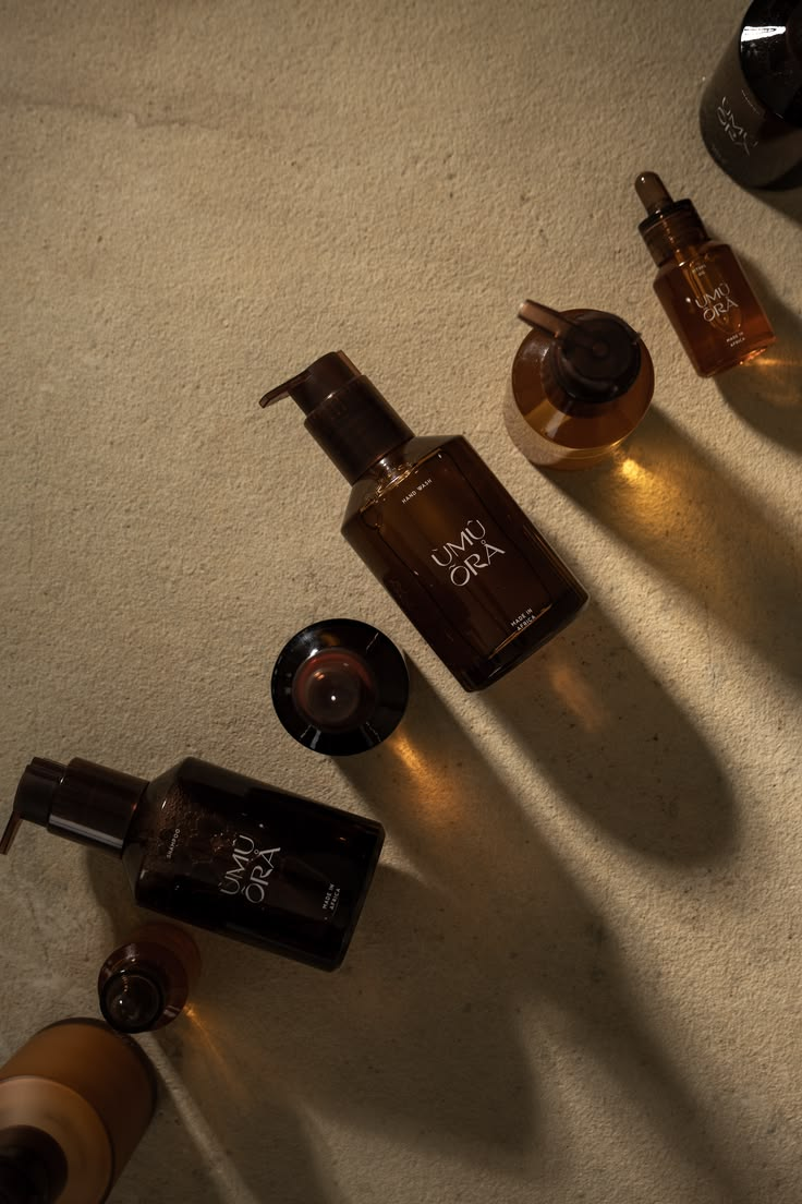Dark perfume bottle lit by a narrow band of warm light