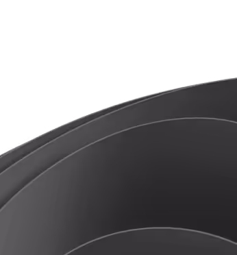 Close-up of overlapping black curved surfaces with subtle highlights.