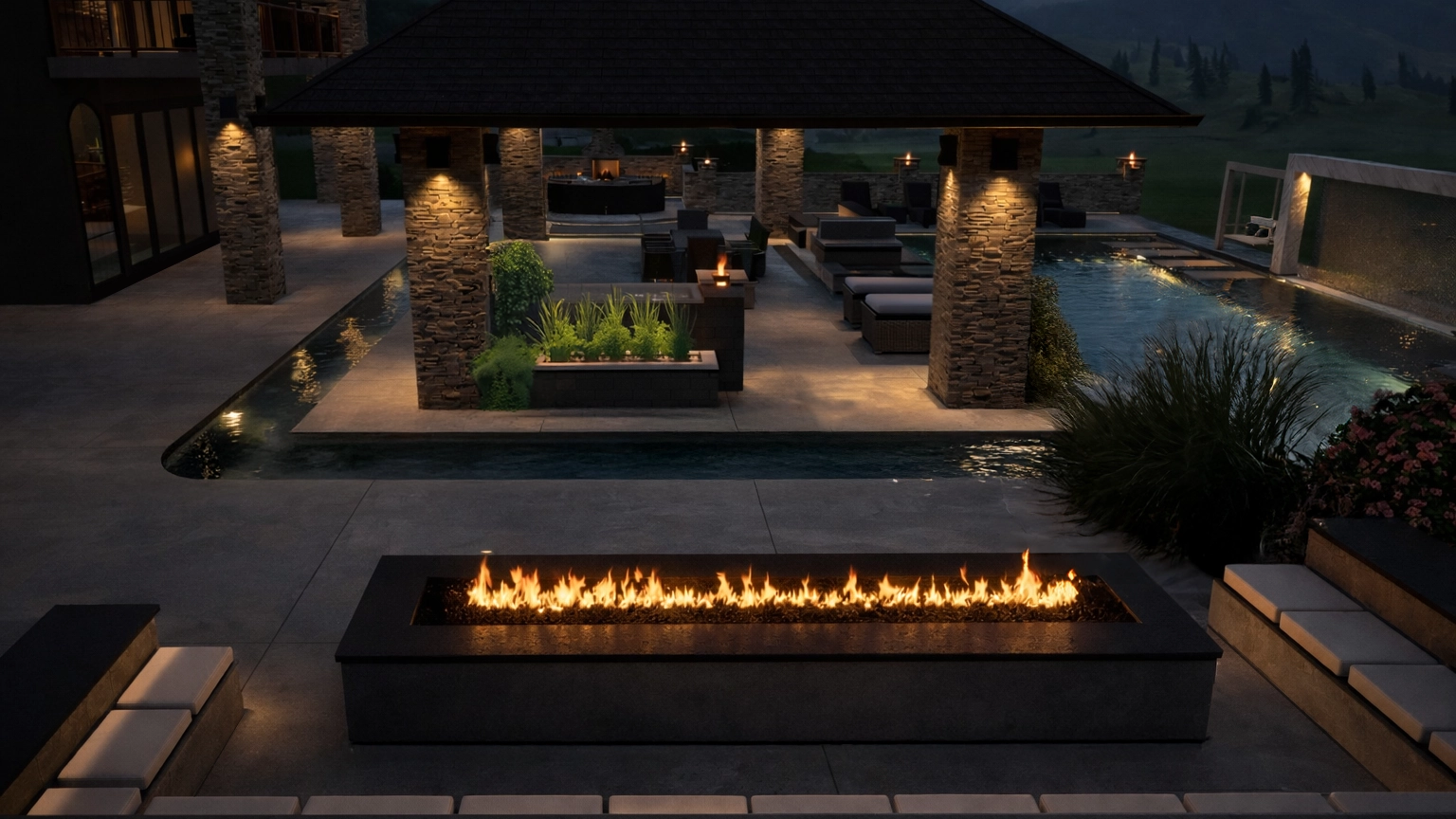 Luxury outdoor living space by Allscape Patio featuring an integrated linear fire feature, architectural concrete surfaces, and a pavilion-centered seating area at dusk.