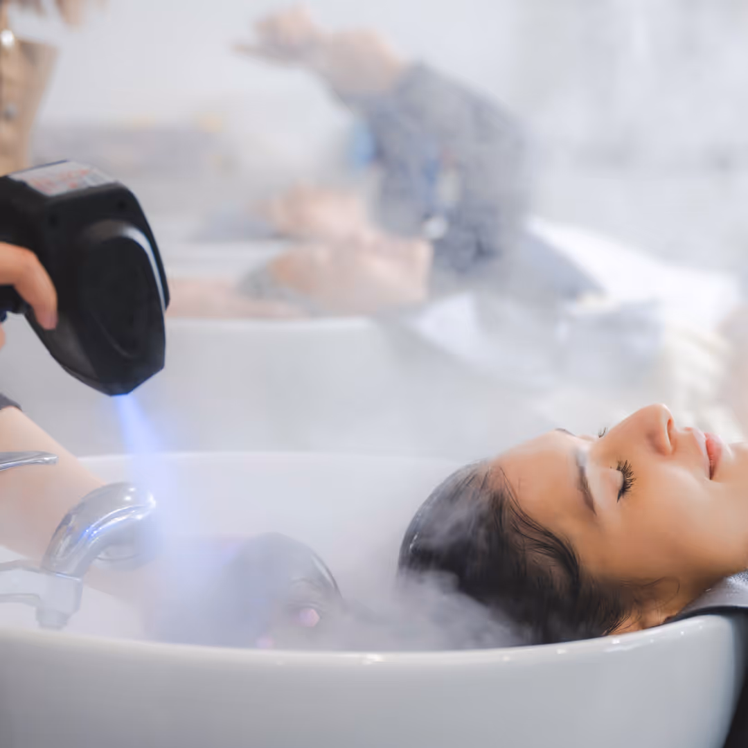 a woman's hair receiving a light therapy treatment
