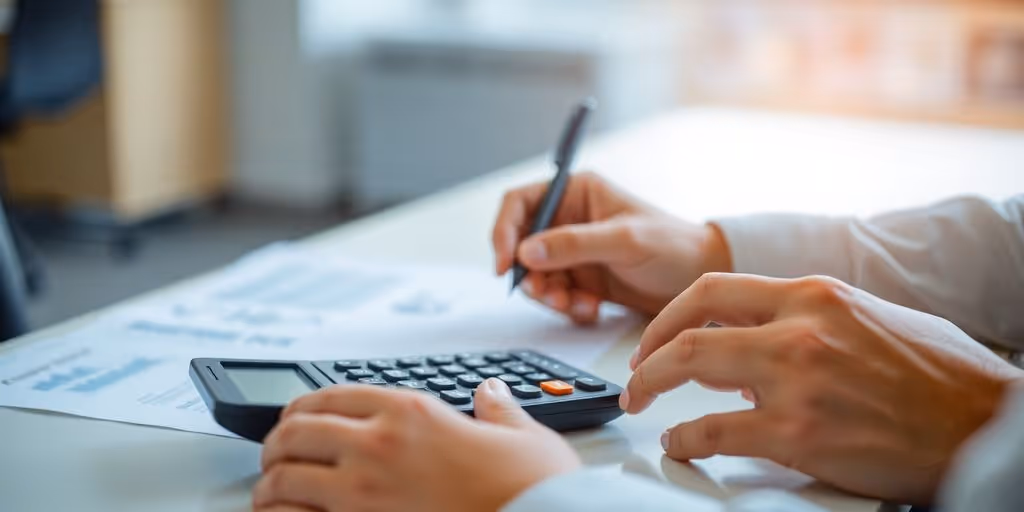 Person calculating finances at desk.