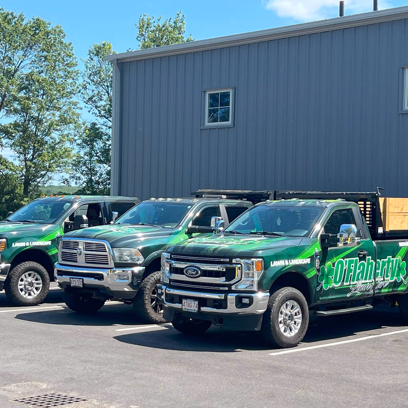 O’Flaherty Lawn Care truck transporting lawn and landscaping equipment