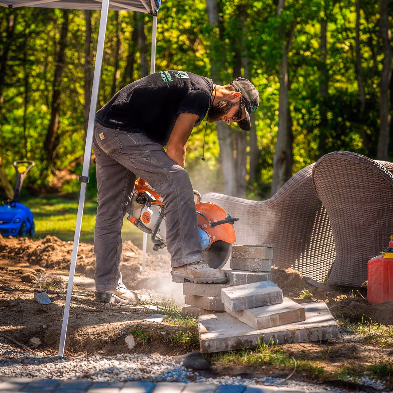 Landscape construction crew building a custom retaining wall and patio by OFlaherty Lawn Care in Attleboro Massachusetts near me