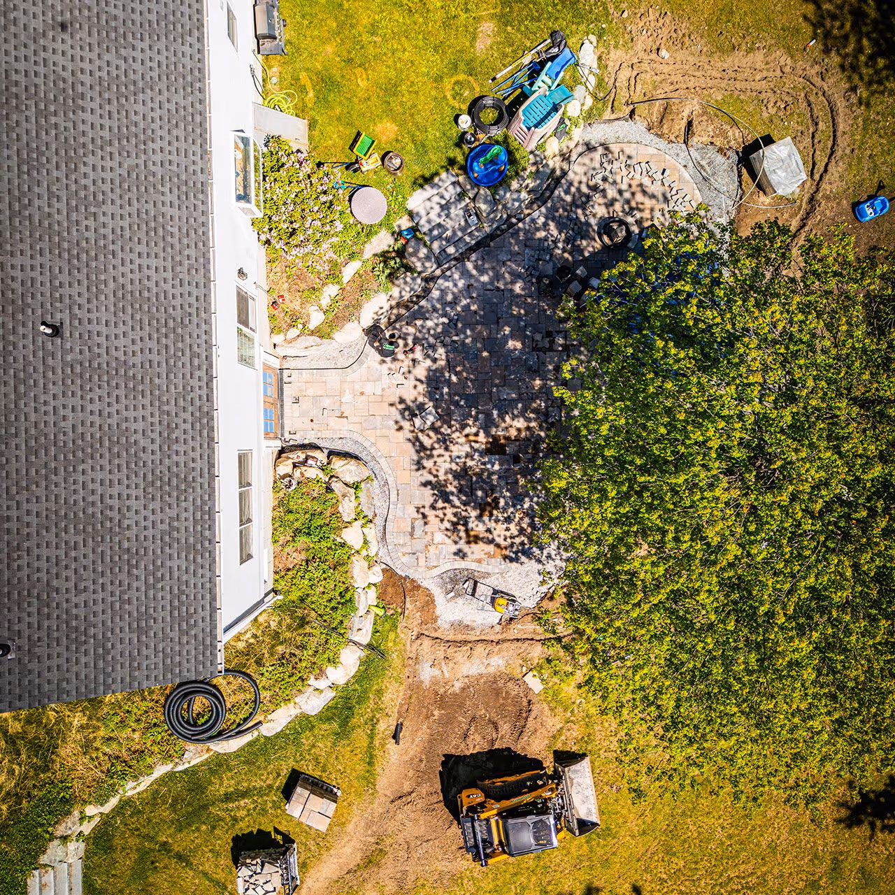 Aerial view of custom hardscaping featuring patios walkways and retaining walls by OFlaherty Lawn Care in Attleboro Massachusetts near me