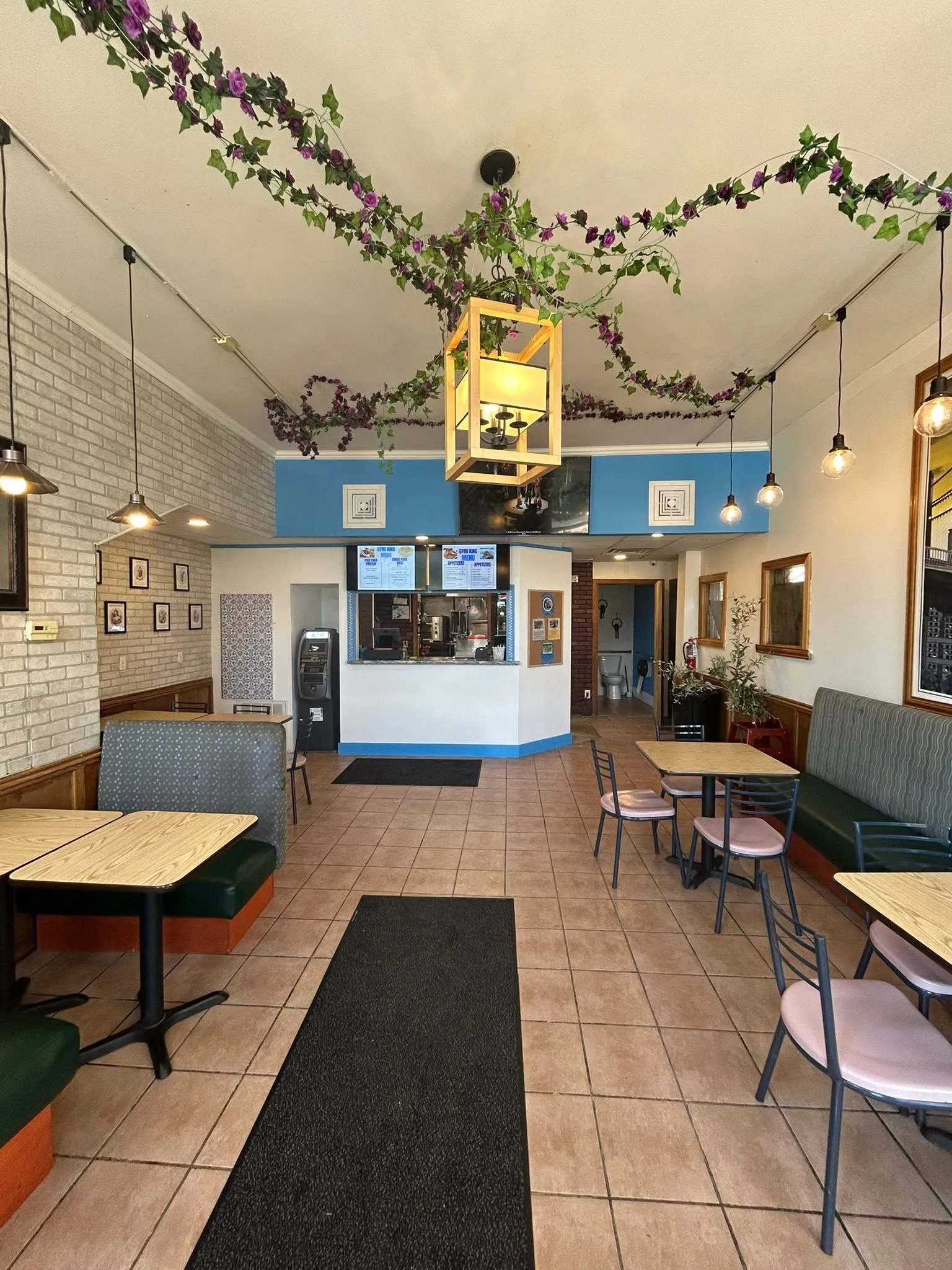 A restaurant with a large hanging plant and a blue and white color scheme.