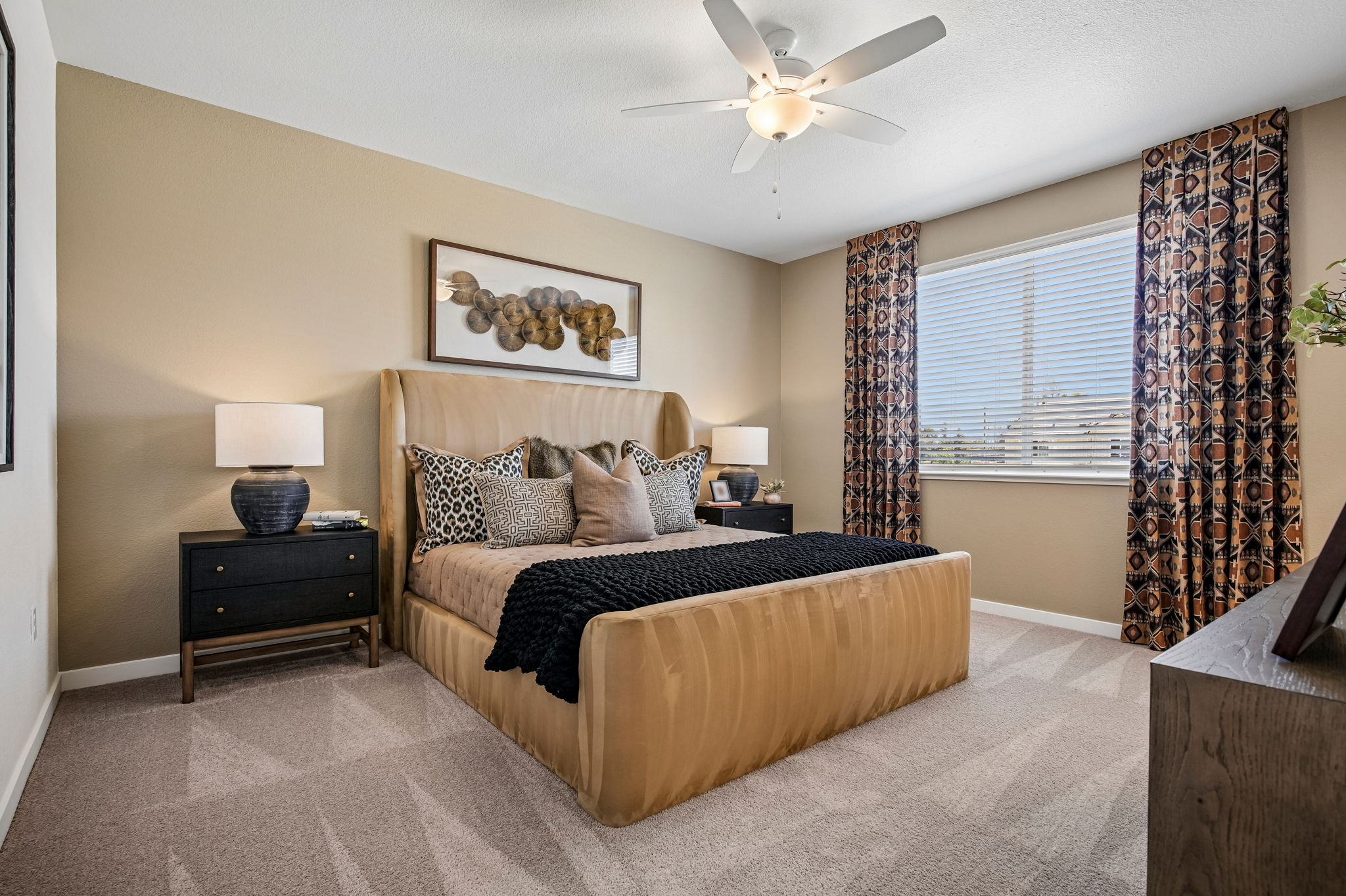 Bedroom with bed, large window, and table with lamps