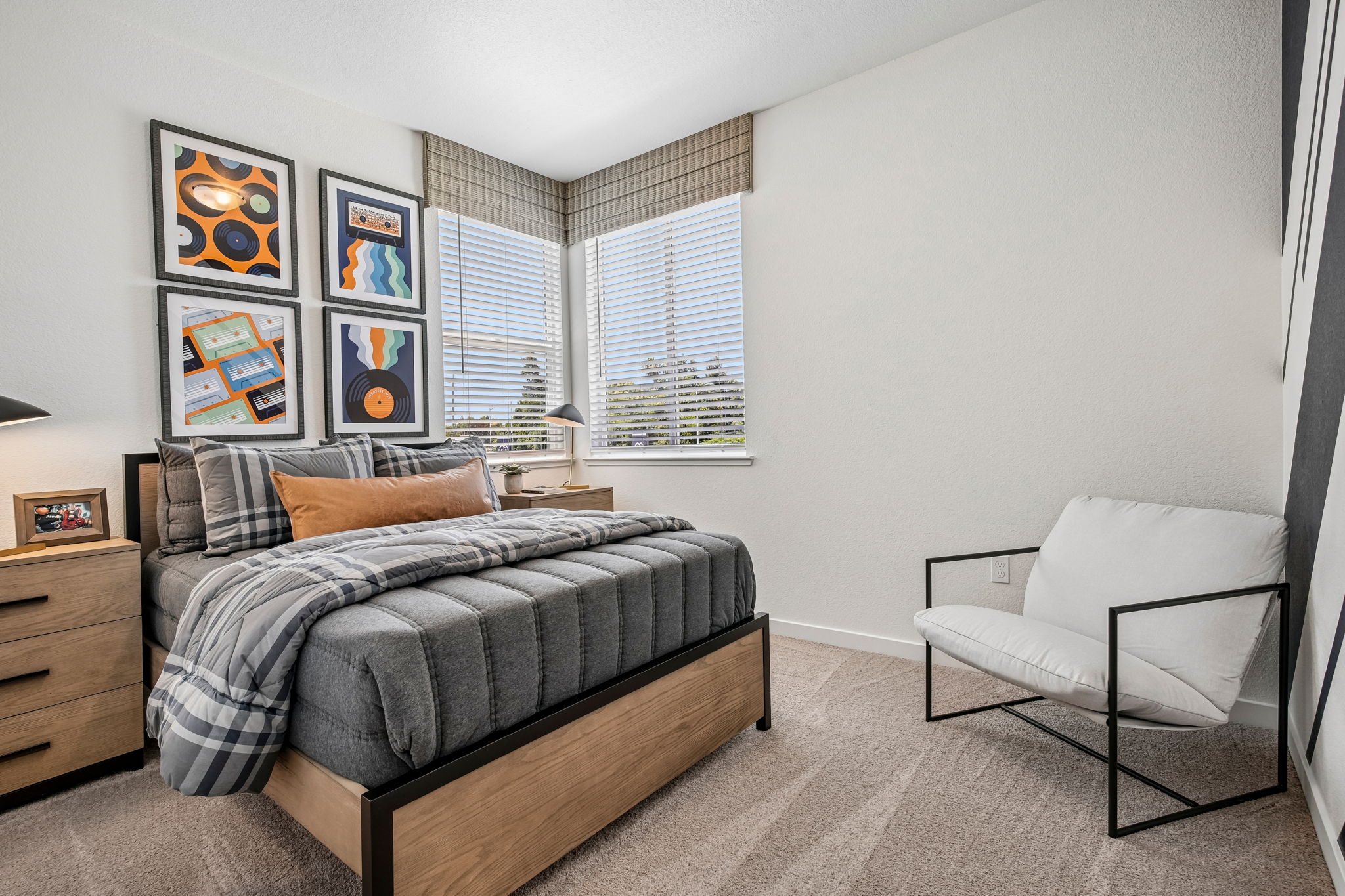 Bedroom with bed, large window, and tables with lamps